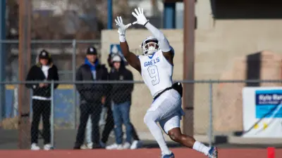Bishop Gorman's Elija Lofton jumps to receive the ball and score a touchdown at the state championship game against Bishop Manogue at Carson High School on Nov. 19