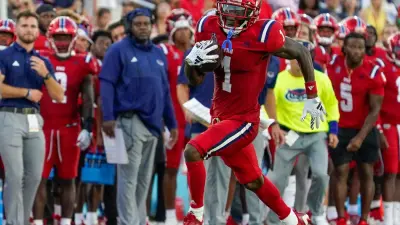 Florida Atlantic wide receiver LaJohntay Wester (1) looks for running room during a 42-20 victory over Monmouth at FAU Stadium on Saturday