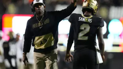 Colorado Buffaloes quarterback Shedeur Sanders (2) and head coach Deion Sanders following a two-point conversion in the fourth quarter against the Colorado State Rams.