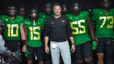 Oregon coach Dan Lanning leads his team onto the field before the game against Colorado in Eugene Saturday