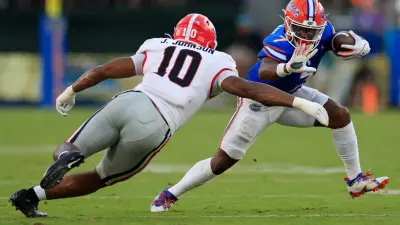 Georgia Bulldogs linebacker Jamon Dumas-Johnson (10) tackles Florida Gators running back Trevor Etienne (7) during the third quarter of an NCAA football game Saturday