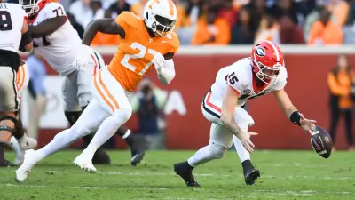 Georgia quarterback Carson Beck (15) fumbles the ball as Tennessee defensive lineman James Pearce Jr. (27) trails him