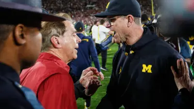 Michigan coach Jim Harbaugh shakes hands with Alabama coach Nick Saban after U-M's 27-20 overtime win over Alabama at Rose Bowl Stadium in Pasadena