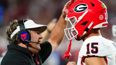 Georgia Bulldogs head coach Kirby Smart talks with quarterback Carson Beck (15) during the first half against the Alabama Crimson Tide at Bryant-Denny Stadium.