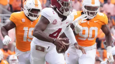 Alabama quarterback Jalen Milroe (4) is pressured by Tennessee defensive linemen Joshua Josephs (19) and Dominic Bailey (90) during an NCAA college football game on Saturday
