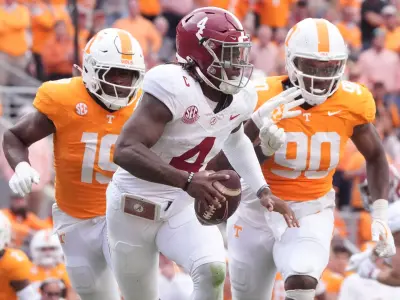 Alabama quarterback Jalen Milroe (4) is pressured by Tennessee defensive linemen Joshua Josephs (19) and Dominic Bailey (90) during an NCAA college football game on Saturday, Oct. 19, 2024, in Knoxville. Tenn.