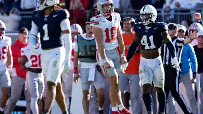 Ohio State Buckeyes quarterback Will Howard (18) reacts beside Penn State Nittany Lions linebacker Kobe King (41) after running for a first down late in the second half of the NCAA football game at Beaver Stadium in University Park