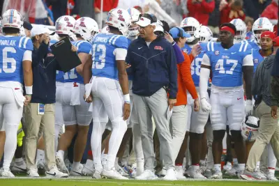Nov 9, 2024; Oxford, Mississippi, USA; Mississippi Rebels head coach Lane Kiffin talks with quarterback Austin Simmons (13) after a touchdown during the first half against the Georgia Bulldogs at Vaught-Hemingway Stadium.
