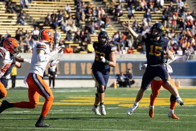 Nov 16, 2024; Berkeley, California, USA; California Golden Bears quarterback Fernando Mendoza (15) passes over two Syracuse Orange defenders during the second quarter at California Memorial Stadium.