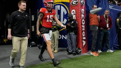 Georgia quarterback Carson Beck (15) takes the field to warm up before the start of the SEC championship game against Texas in Atlanta