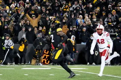Iowa Hawkeyes running back Kaleb Johnson (2) runs to the endzone to score a touchdown as Nebraska Cornhuskers linebacker Mikai Gbayor (42) trails Friday, Nov. 29, 2024 at Kinnick Stadium in Iowa City, Iowa.