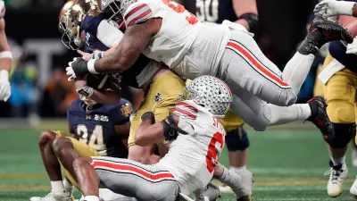 Ohio State Buckeyes safety Sonny Styles (6) and defensive tackle Tyleik Williams (91) sacks Notre Dame Fighting Irish quarterback Riley Leonard (13) in the third quarter during the College Football Playoff championship at Mercedes-Benz Stadium in Atlanta on January 20