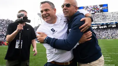 Penn State athletic director Pat Kraft gives head football coach James Franklin a big hug following a 33-24 win over Indiana at Beaver Stadium Saturday