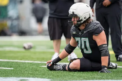 Combat Ducks offensive lineman Charlie Pickard stretches before the game as the Fighting Ducks face off against Mighty Oregon in the Oregon Ducks spring game on April 26, 2025, at Autzen Stadium in Eugene.