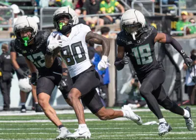 Oregon Fighting Duck Dillon Graham breaks out for the winning touchdown against the Fighting Ducks Peyton Woodyard, left, and Dorian Brew during the fourth quarter of the Oregon Spring Game at Autzen Stadium in Eugene April 26, 2025