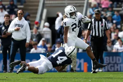Apr 26, 2025; University Park, PA, USA; Penn State Nittany Lions running back Corey Smith (24) runs with the ball while trying to avoid a tackle from safety Braz Thomas (14) during the third quarter of the Blue White spring game at Beaver Stadium. The White team defeated the Blue team 10-8. 