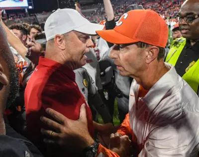 Nov 2, 2024; Clemson, South Carolina, USA; Louisville Cardinals head coach Jeff Brohm (left) meets with Clemson Tigers head coach Dabo Swinney after a game at Memorial Stadium. Louisville won 33-21
