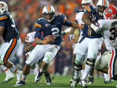 Nov 13, 2010; Auburn, AL, USA; Auburn Tigers quarterback Cam Newton (2) runs for a first down against the Georgia Bulldogs in the second half at Jordan-Hare Stadium. Auburn defeated Georgia 49-31.