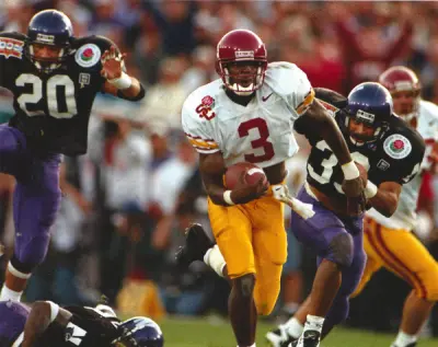 Jan 1, 1996; Pasadena, CA, USA; Southern California Trojans receiver Keyshawn Johnson (3) scores on a 56-yard touchdown reception during the third quarter against the Northwestern Wildcats at the Rose Bowl. USC defeated Northwestern 41-32.