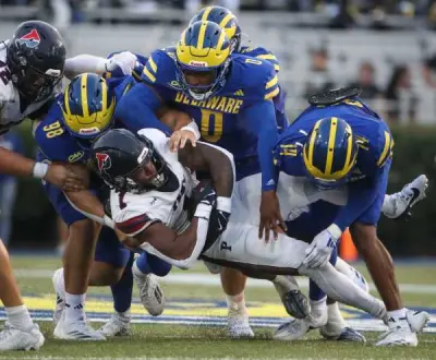 Delaware's Nick Karika (98) Q'yaeir Price (0) and K.T. Seay tackle Penn running back Malachi Hosley in the second quarter at Delaware Stadium, Saturday, Sept. 21, 2024.