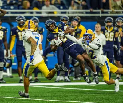 Toledo Rockets wide receiver Junior Vandeross III (2) makes a catch to get the first down against Pittsburgh Panthers defensive back Cruce Brookins (12) that lead to a tying field goal, in the fourth quarter of the 2024 GameAbove Sports Bowl at Ford Field in Detroit, on Thursday, Dec. 26, 2024.