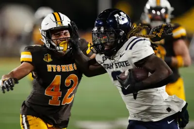 Oct 26, 2024; Laramie, Wyoming, USA; Utah State Aggies running back Rahsul Faison (3) runs against the Wyoming Cowboys during the second quarter at Jonah Field at War Memorial Stadium. 